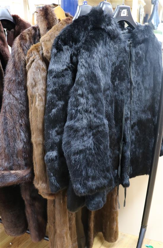 Two black coney coats and two others
